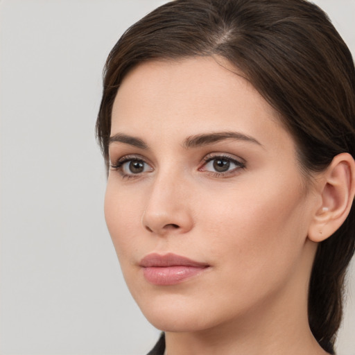 Neutral white young-adult female with long  brown hair and brown eyes