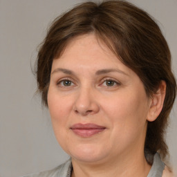 Joyful white adult female with medium  brown hair and brown eyes