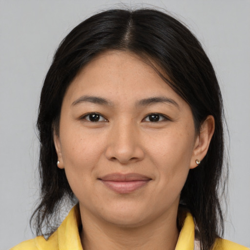 Joyful asian adult female with medium  brown hair and brown eyes