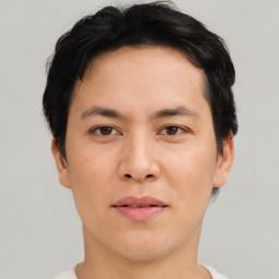 Joyful asian young-adult male with short  brown hair and brown eyes