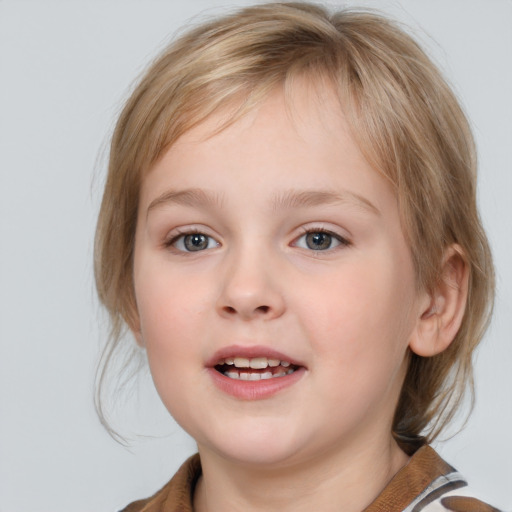 Joyful white child female with medium  brown hair and blue eyes