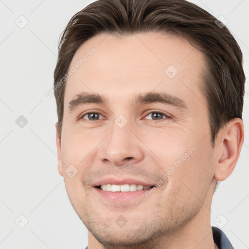 Joyful white young-adult male with short  brown hair and brown eyes