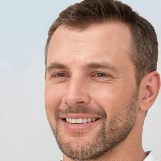 Joyful white adult male with short  brown hair and brown eyes