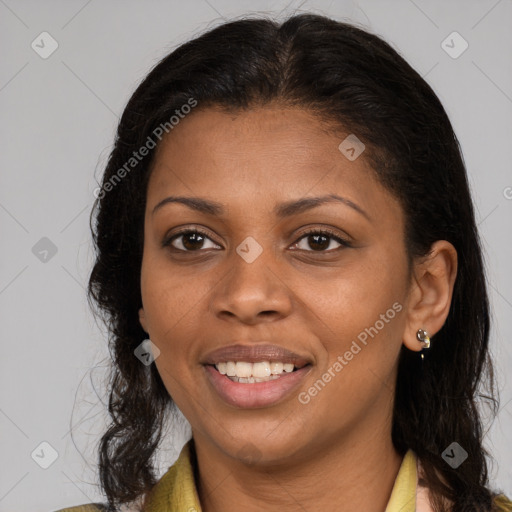 Joyful black young-adult female with long  brown hair and brown eyes