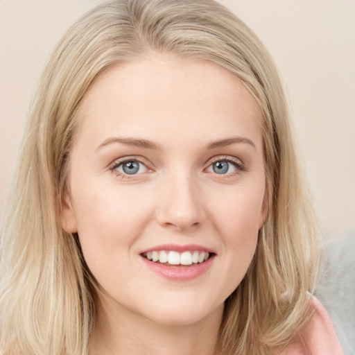 Joyful white young-adult female with long  brown hair and blue eyes