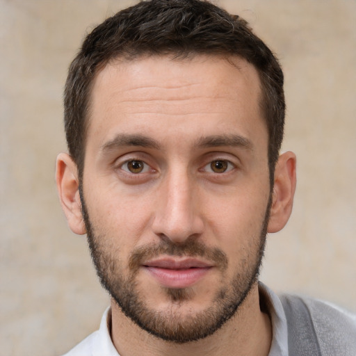 Joyful white young-adult male with short  brown hair and brown eyes