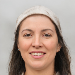 Joyful white adult female with long  brown hair and brown eyes