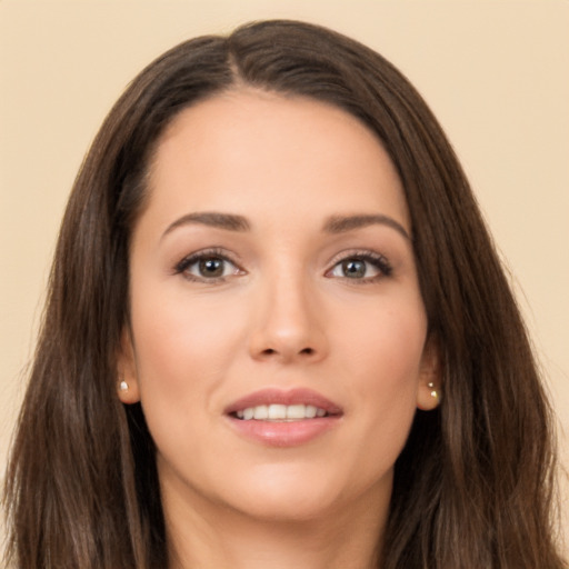 Joyful white young-adult female with long  brown hair and brown eyes