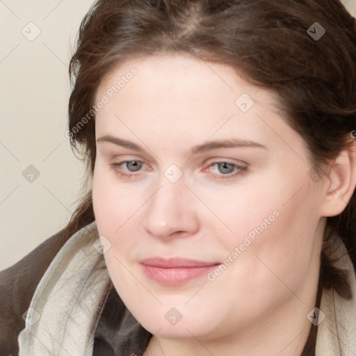 Joyful white young-adult female with medium  brown hair and blue eyes