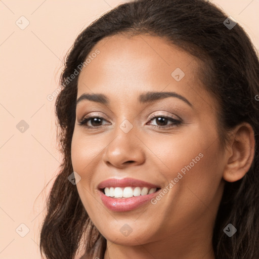 Joyful white young-adult female with long  brown hair and brown eyes