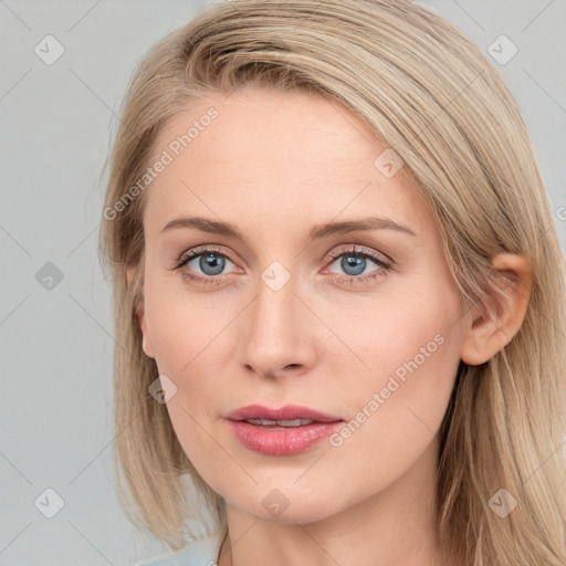 Joyful white young-adult female with long  brown hair and blue eyes