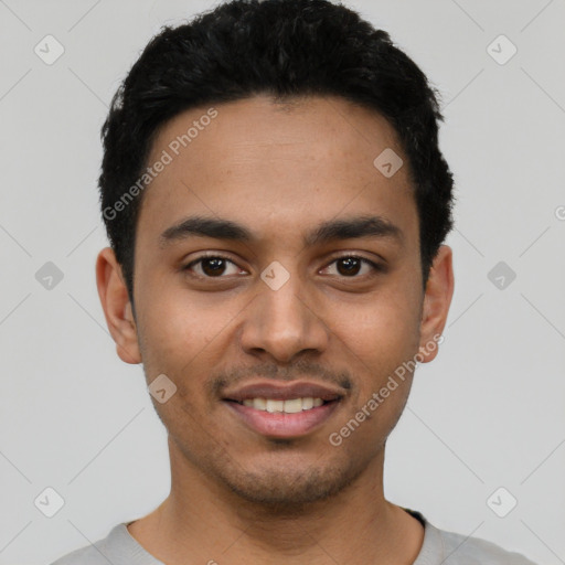 Joyful latino young-adult male with short  black hair and brown eyes