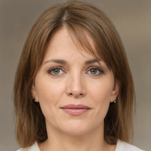 Joyful white young-adult female with medium  brown hair and green eyes