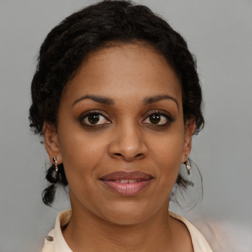 Joyful black young-adult female with medium  brown hair and brown eyes