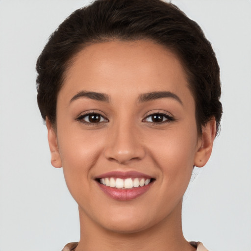 Joyful white young-adult female with short  brown hair and brown eyes