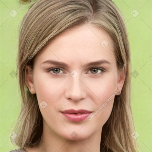 Joyful white young-adult female with long  brown hair and green eyes