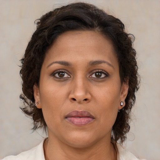 Neutral black young-adult female with medium  brown hair and brown eyes
