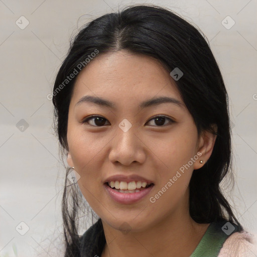 Joyful asian young-adult female with medium  black hair and brown eyes