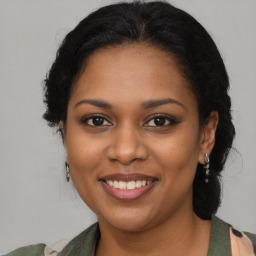 Joyful black young-adult female with medium  brown hair and brown eyes