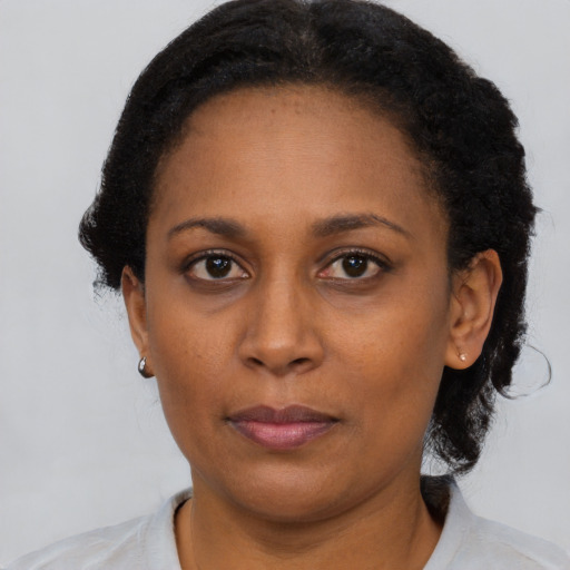 Neutral black adult female with short  black hair and brown eyes