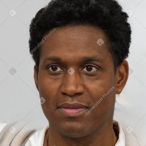 Joyful black young-adult male with short  black hair and brown eyes