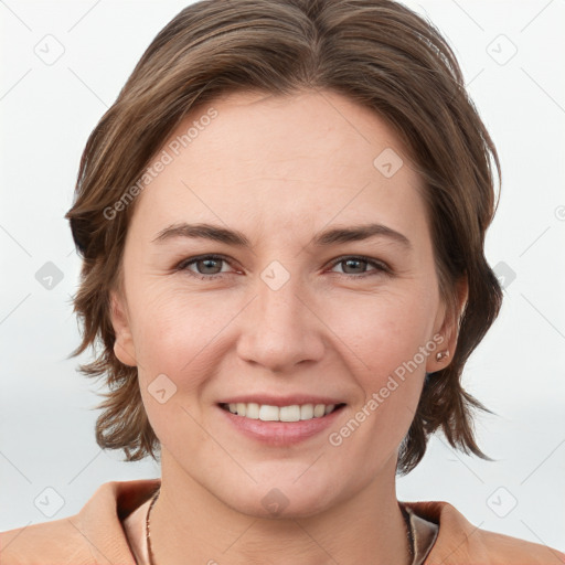 Joyful white young-adult female with medium  brown hair and grey eyes