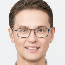 Joyful white young-adult male with short  brown hair and grey eyes