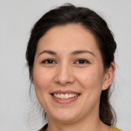 Joyful white young-adult female with medium  brown hair and brown eyes