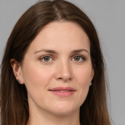 Joyful white young-adult female with long  brown hair and green eyes