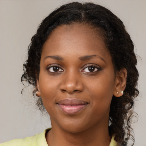 Joyful black young-adult female with medium  brown hair and brown eyes