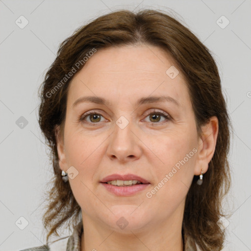 Joyful white adult female with medium  brown hair and green eyes