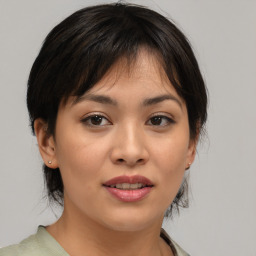 Joyful asian young-adult female with medium  brown hair and brown eyes