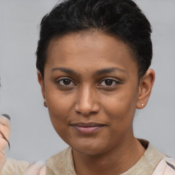 Joyful latino young-adult female with short  black hair and brown eyes