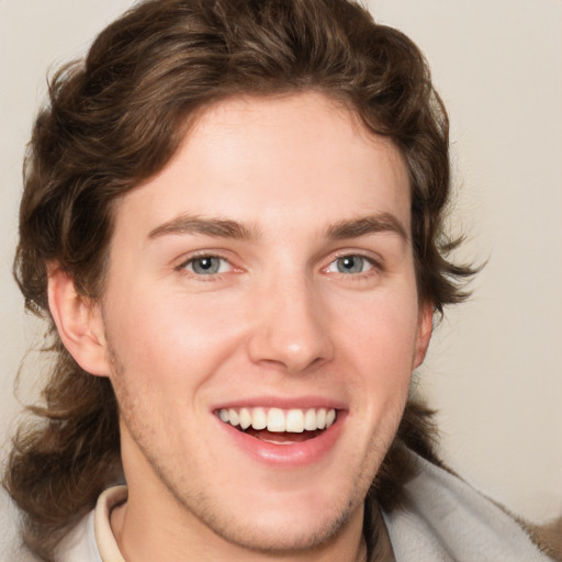 Joyful white young-adult male with medium  brown hair and brown eyes