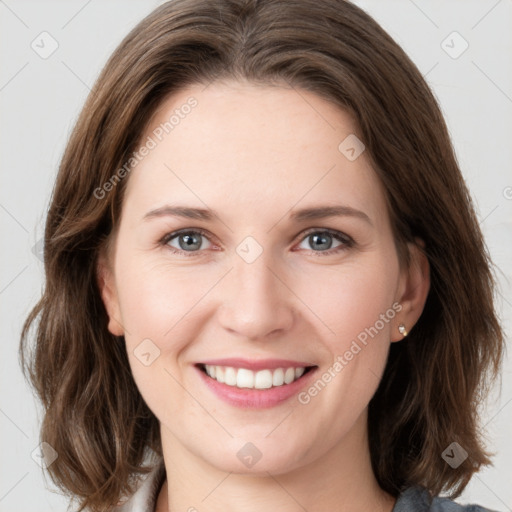 Joyful white young-adult female with medium  brown hair and grey eyes