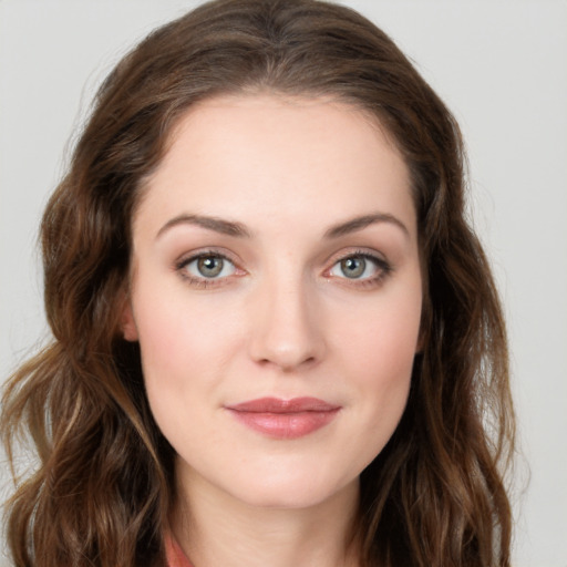 Joyful white young-adult female with long  brown hair and green eyes