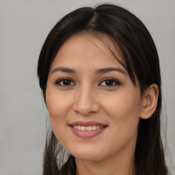 Joyful asian young-adult female with long  brown hair and brown eyes