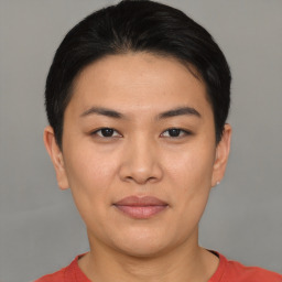 Joyful asian young-adult female with short  black hair and brown eyes