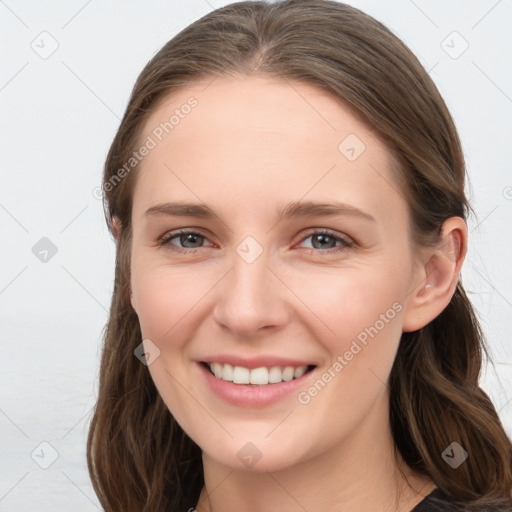 Joyful white young-adult female with long  brown hair and grey eyes