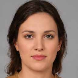 Joyful white young-adult female with medium  brown hair and green eyes