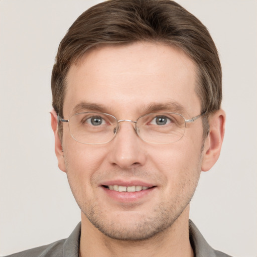 Joyful white adult male with short  brown hair and grey eyes