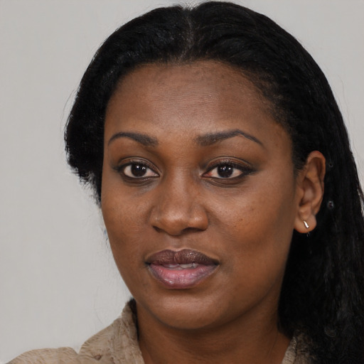 Joyful black young-adult female with long  black hair and brown eyes