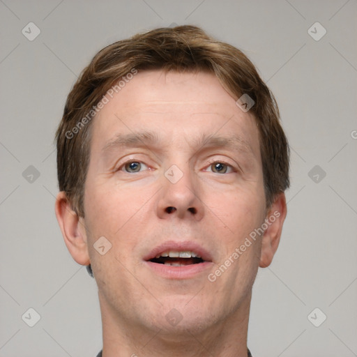 Joyful white adult male with short  brown hair and grey eyes