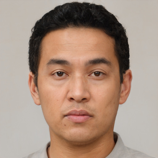 Neutral latino young-adult male with short  black hair and brown eyes
