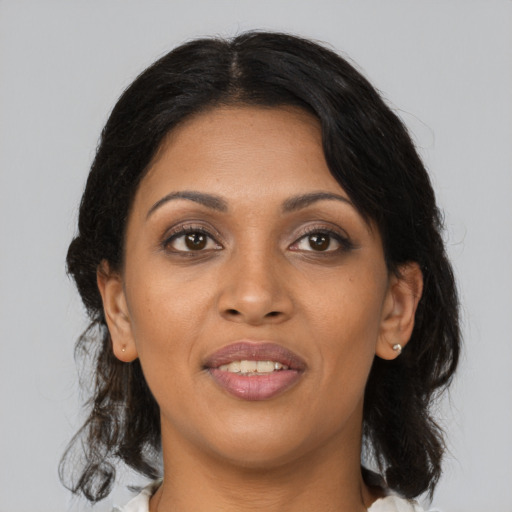 Joyful black young-adult female with medium  black hair and brown eyes
