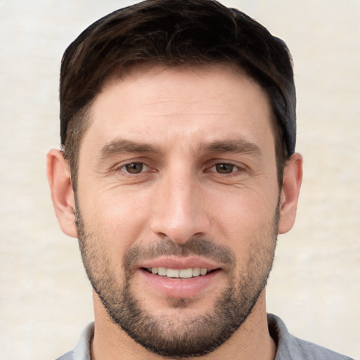 Joyful white young-adult male with short  brown hair and brown eyes