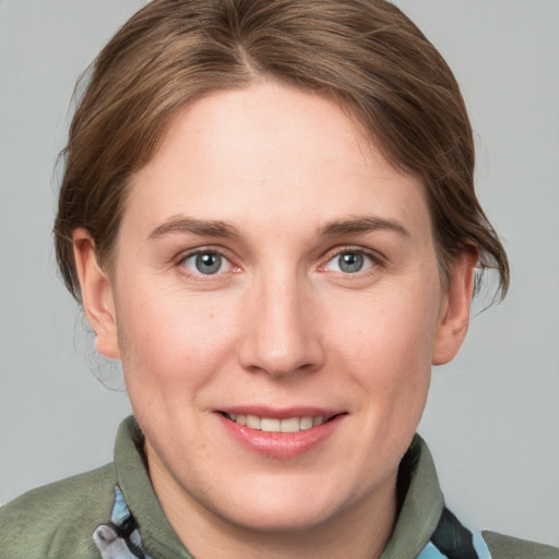 Joyful white young-adult female with medium  brown hair and grey eyes