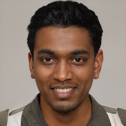 Joyful black young-adult male with short  black hair and brown eyes