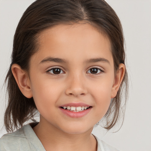 Joyful white child female with medium  brown hair and brown eyes