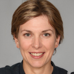 Joyful white adult female with medium  brown hair and grey eyes